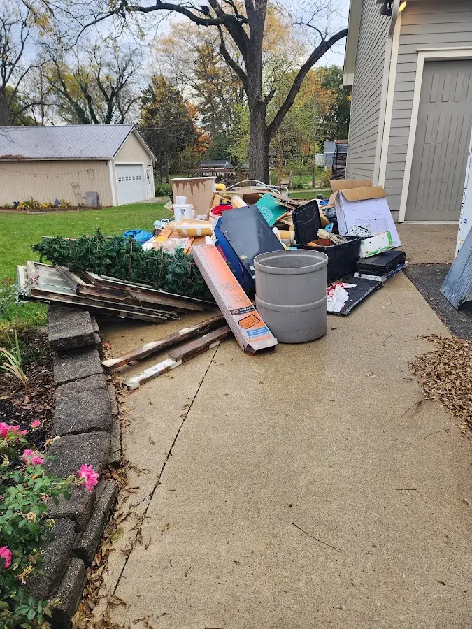 Dumpster being loaded with debris for Estate Cleanout Dumpster Rental in Middle
